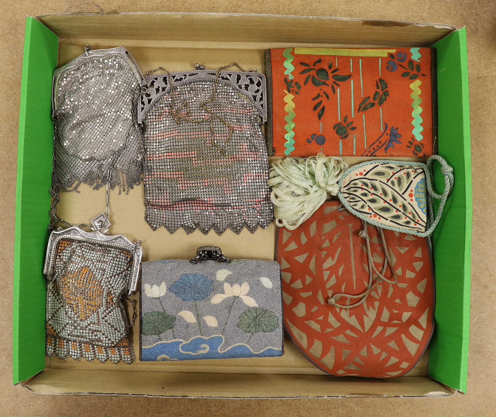 A group of unusual Art Deco bags: two hand printed suede purses and a similar bag, a Japanese embroidered purse to hang from an Obi and three ornate metal bags
